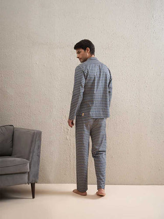 a men standing and weared a dark grey full sleeve front open pyjama set