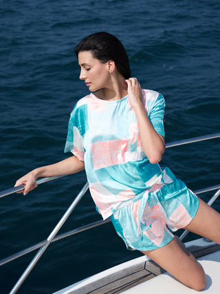 a women on a boat wearing a malibu abstarct half sleeve short sets