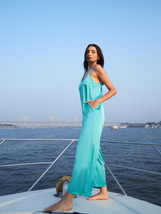 A women on a yoat wearing malibu blue jumpsuit for women