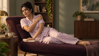 Woman in orchid floral pyjamas resting in a reading room after a restless night