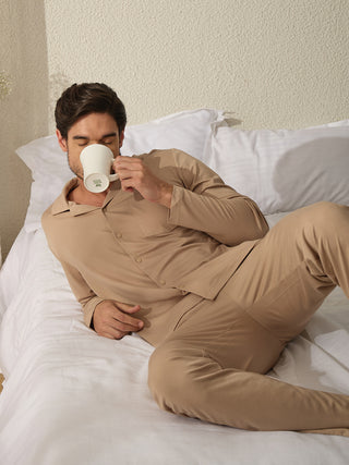 Men lounging in a beige pajama set.