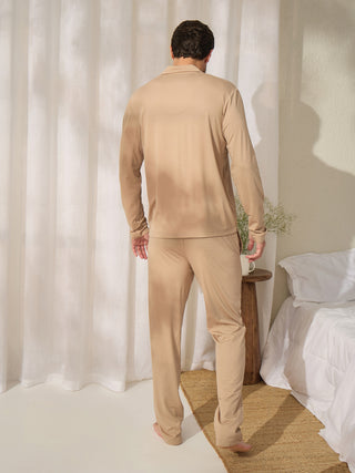 Men wearing a beige long-sleeved pajama set with a collared top and long pants.