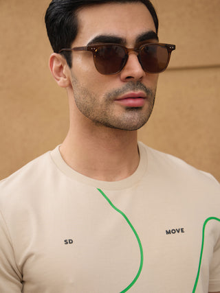 Men wearing a light beige t-shirt with abstract green lines and text prints.