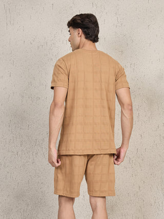 Men's camel checkered t-shirt and shorts set, the man is seen from behind.