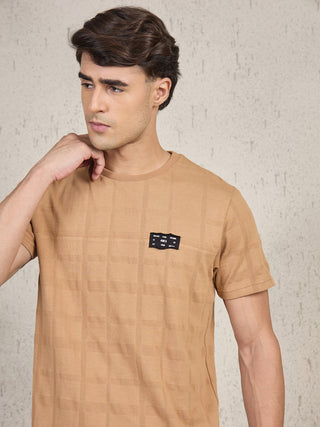 Men's camel checkered t-shirt and shorts set, the man is seen from behind.