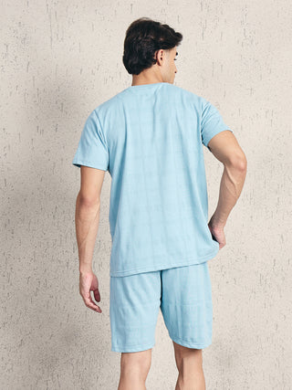 Men wearing a light blue, textured pajama set.