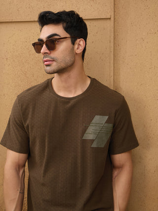 Men are featured in sleepwear, with one person posing and wearing a dark brown t-shirt with a textured print.