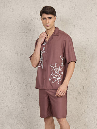 Men wearing a brown printed linen shirt and shorts set, standing, with white floral embroidery.