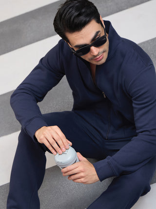 Men's navy blue loungewear set, person holding a small grey container.