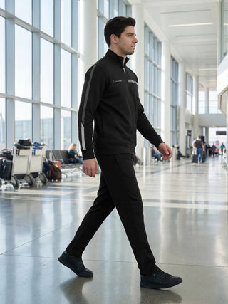 Men walking in a black tracksuit with grey accents.