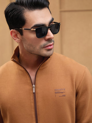 Men wearing a brown zip-up sweatshirt with a small dark brown print.