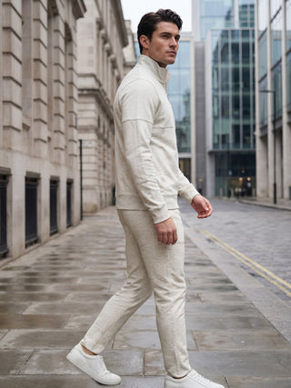 Men's light beige tracksuit, walking outdoors.