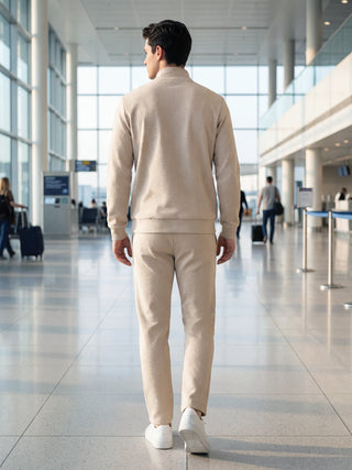 Men walking away from camera wearing a beige waffle knit loungewear set.