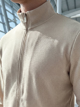 Men wearing a beige textured zip-up sweater.