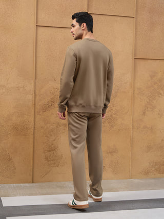 Men in a tracksuit, standing with back to camera.