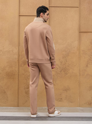 Men wearing a beige loungewear set, standing with back to the camera.