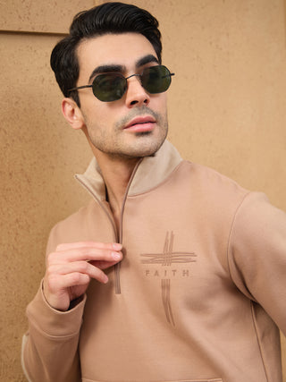 Men's tan quarter-zip sweatshirt with a debossed cross and "FAITH" graphic.