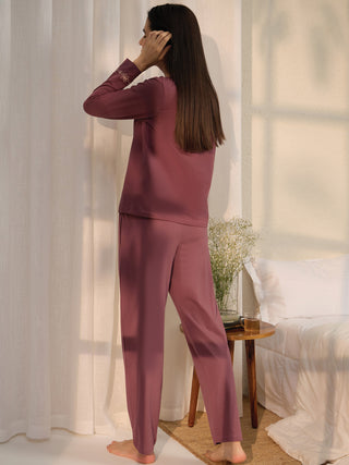 Women's plum long-sleeved pajama set with floral embroidery on the sleeves.