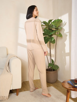 Women in a beige loungewear set standing with their back to the camera.