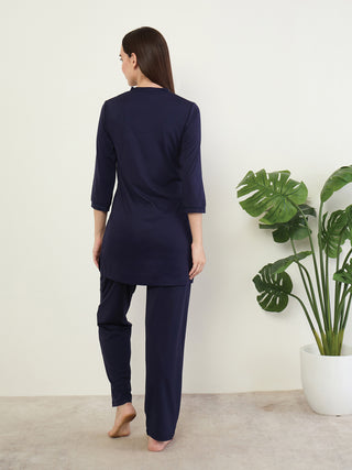 Women wearing navy blue sleepwear, standing with their back to the camera.