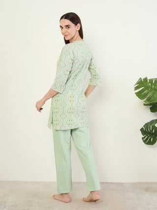 Women posing wearing a mint green printed tunic and mint green palazzo pants.