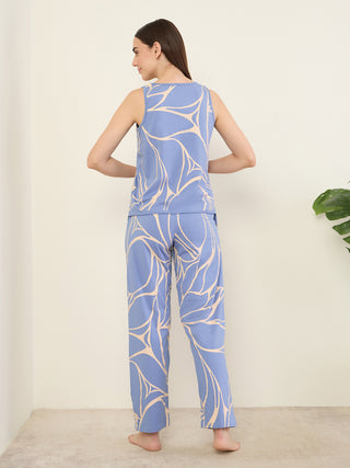 Women's blue sleeveless top and pants set with a white leaf print.