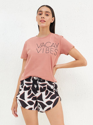 a women standing and weared pink shorts sets
