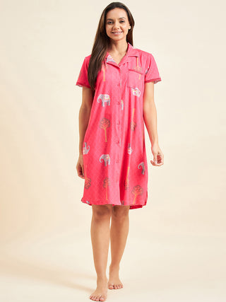 Women wearing a short-sleeved pink button-down nightgown with an elephant and tree print.