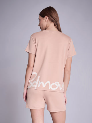 Women's peach shorts and t-shirt set with a white graphic print.