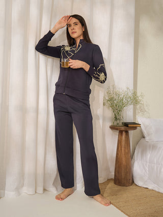 A woman in a dark navy printed pajama set.