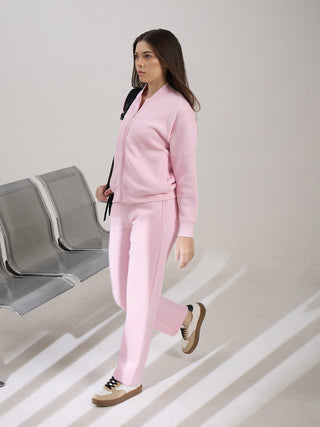 Women walking in a pink tracksuit.