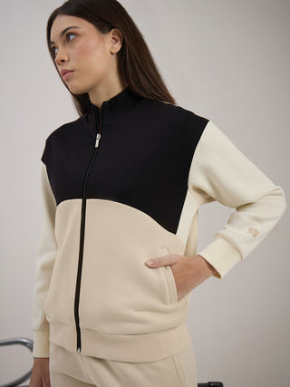 Women in a beige and black colorblocked tracksuit with a zipper.