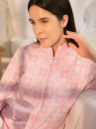 Woman posing in a pink floral print zipper sleepsuit.