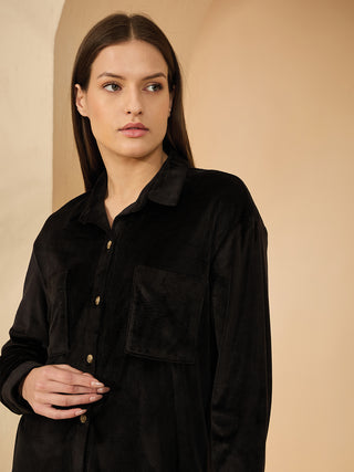 Women wearing a black corduroy long-sleeve button-up shirt with a collar and two chest pockets.