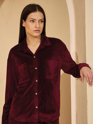 Women in a maroon corduroy pajama set.
