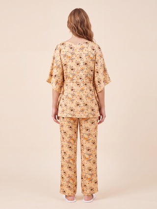 Women's peach floral print pajama set, viewed from the back.