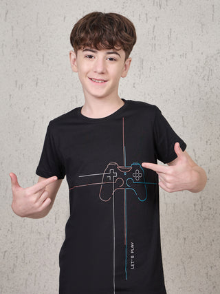 BOYS, a boy in a black t-shirt with a gamepad print and the text "LET'S PLAY" pointing to the print on the shirt.