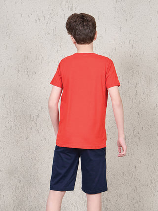 BOYS wearing a plain red t-shirt and navy blue shorts.