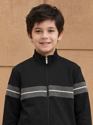 BOYS wearing a black zip-up jacket with gray and white stripes.