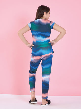 Girls in a colorful tie-dye pajama set, with a new pink and blue tie-dye print.