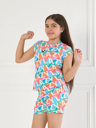 Girls, wearing a colorful, patterned sleepwear set with a panda logo, flex their arms and smile at the camera.