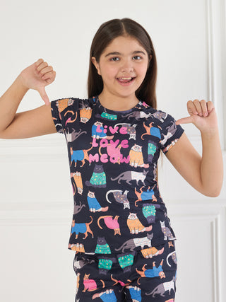GIRLS navy blue pajama set with an all-over cat print featuring various felines in different poses and colors.