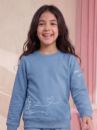 GIRLS wearing a blue sweatshirt with a dachshund and heart print.