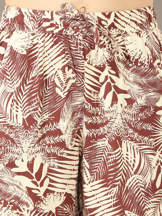 Women's rust-colored palm print pajama pants with a drawstring waist.