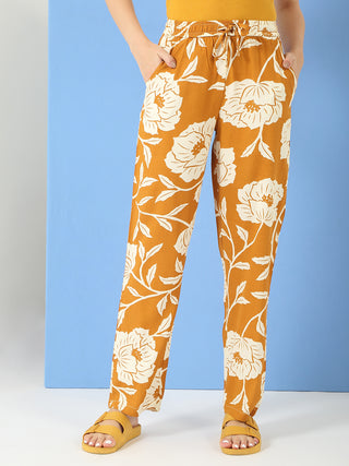 Women wearing brown floral print palazzo pants.