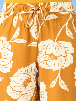 Women's orange and white floral print wide-leg pajama pants with a drawstring waist.