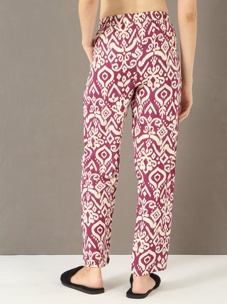 Women in a relaxed pose are wearing maroon printed cotton pants.