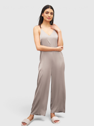 a women wearing a brandy brown silky jumpsuit made signature satin