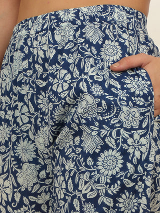 Women's navy blue floral print pajama shorts, with a hand in the pocket.