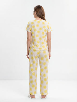 Women's light yellow pajama set with a lemon print, back view.